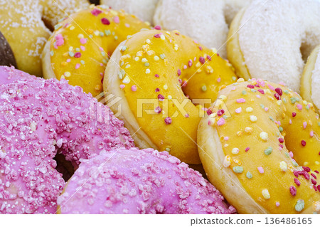 Assorted donuts with pink, yellow, and white glaze Assorted donuts with pink, yellow, and white glaze 136486165