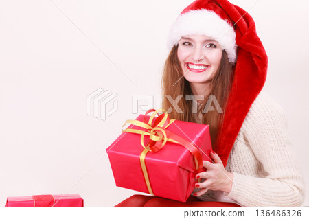 Woman holding gift box. Christmas time 136486326
