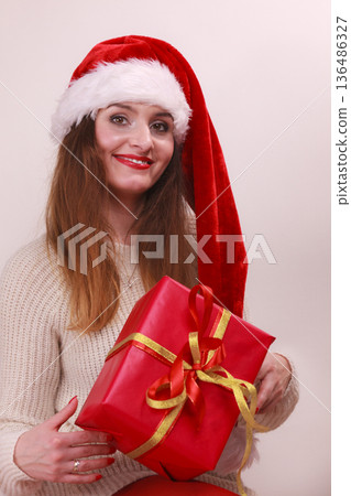 Woman holding gift box. Christmas time 136486327