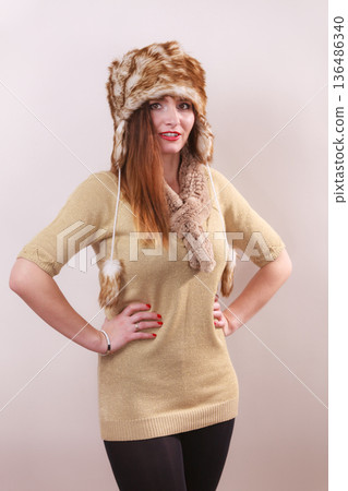 Winter woman in warm clothing fur cap Winter woman in warm clothing fur cap 136486340