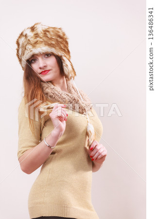 Winter woman in warm clothing fur cap Winter woman in warm clothing fur cap 136486341
