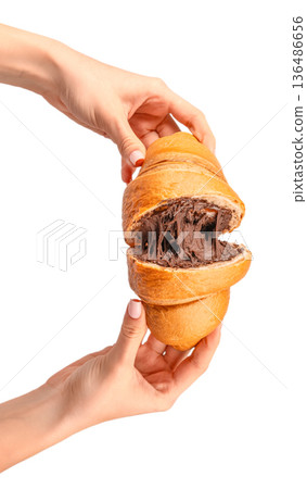 Woman holding split croissant filled with rich chocolate cream isolated on white Woman holding split croissant filled with rich chocolate cream isolated on white 136486656