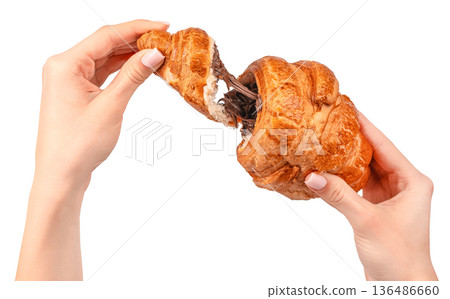 Woman tearing croissant with melted chocolate filling isolated on white 136486660