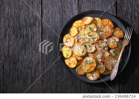 Roasted Potato Slices with Parmesan Cheese Top View Roasted Potato Slices with Parmesan Cheese Top View 136486724