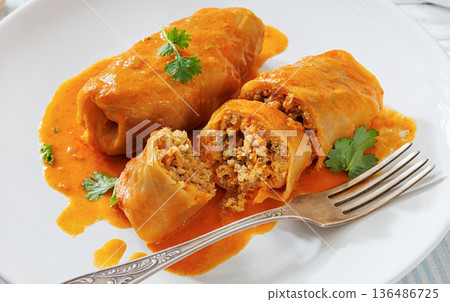 Stuffed cabbage rolls with quinoa and tomato sauce Stuffed cabbage rolls with quinoa and tomato sauce 136486725