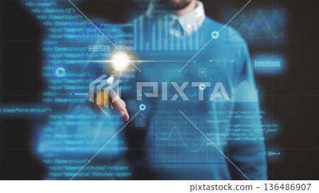 Person uses digital tools to analyze data on a transparent screen in an office 136486907