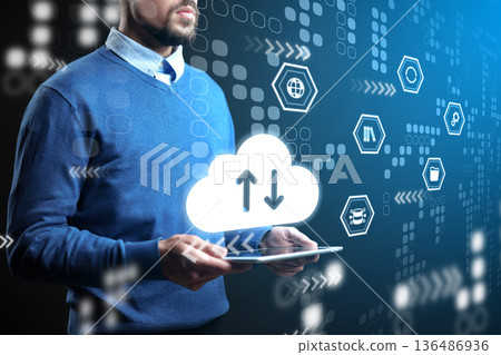 Man using tablet for cloud data exchange in digital environment with various icons Man using tablet for cloud data exchange in digital environment with various icons 136486936