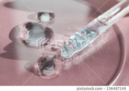 Pipette dripping transparent serum droplets, highlighting skincare innovation and cosmetic beauty Pipette dripping transparent serum droplets, highlighting skincare innovation and cosmetic beauty 136487149