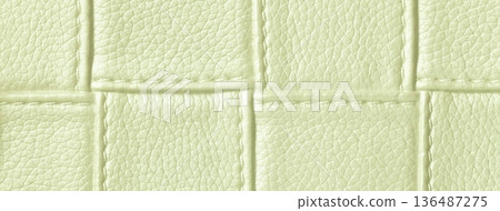 Texture light green leather background with quilted stitched pattern, macro. Abstract pastel olive upholstery surface Texture light green leather background with quilted stitched pattern, macro. Abstract pastel olive upholstery surface 136487275