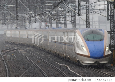 Light snow falls on the Joetsu Shinkansen and Hokuriku Shinkansen E7 series trains Light snow falls on the Joetsu Shinkansen and Hokuriku Shinkansen E7 series trains 136487448
