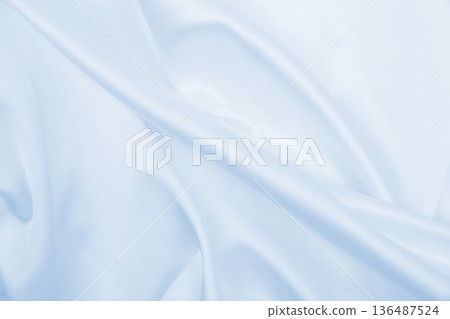 Smooth elegant blue silk or satin luxury cloth texture as abstract background. Luxurious background design Smooth elegant blue silk or satin luxury cloth texture as abstract background. Luxurious background design 136487524