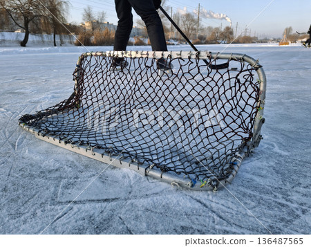 Hockey players play hockey on a frozen pond. Winter sports Hockey players play hockey on a frozen pond. Winter sports 136487565