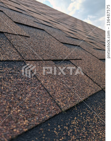 Private home roof finished with bituminous shingles Private home roof finished with bituminous shingles 136487575