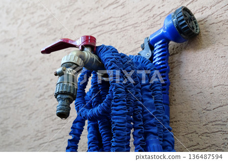 Outdoor tap for watering a garden plot. Water tap outside the building Outdoor tap for watering a garden plot. Water tap outside the building 136487594