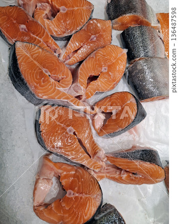 Red fish cut into pieces on an ice stand in a supermarket Red fish cut into pieces on an ice stand in a supermarket 136487598