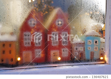 Colorful houses and garland in the window of Christmas toy store Colorful houses and garland in the window of Christmas toy store 136487621