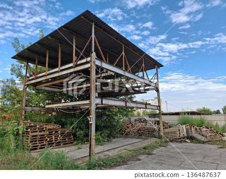Old abandoned unused rusty metal puzzle parking system in a residential area 136487637