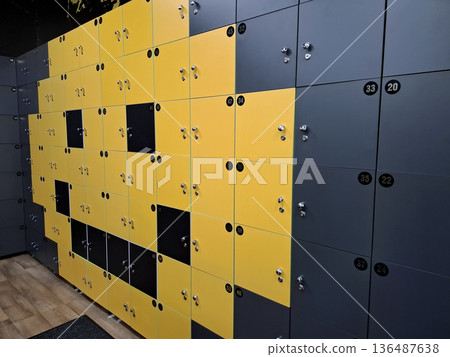 Clients lockers with numbers and locks in a gym. Smiling face Clients lockers with numbers and locks in a gym. Smiling face 136487638