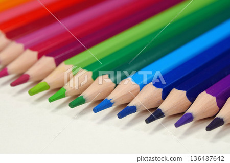 New wooden colored pencils of rainbow colors, perfectly sharpened, lie on table New wooden colored pencils of rainbow colors, perfectly sharpened, lie on table 136487642