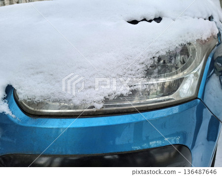 Snow lies on a blue car Snow lies on a blue car 136487646