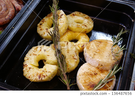 Pineapples cutted rings and little fried 136487656