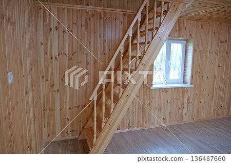 A new wooden staircase leading to the second floor of the house A new wooden staircase leading to the second floor of the house 136487660