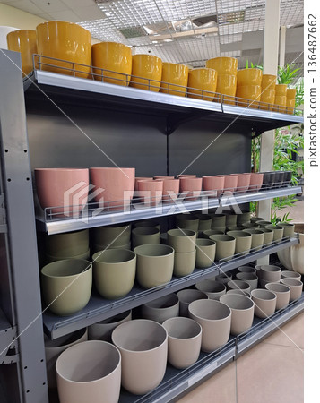 Ceramic flower pots on supermarket shelves. Ceramic products in flower shop Ceramic flower pots on supermarket shelves. Ceramic products in flower shop 136487662