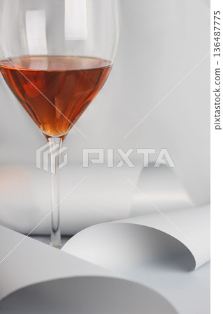 Rose Wine Glass on Minimal White Background. Elegant Modern Beverage Concept Rose Wine Glass on Minimal White Background. Elegant Modern Beverage Concept 136487775
