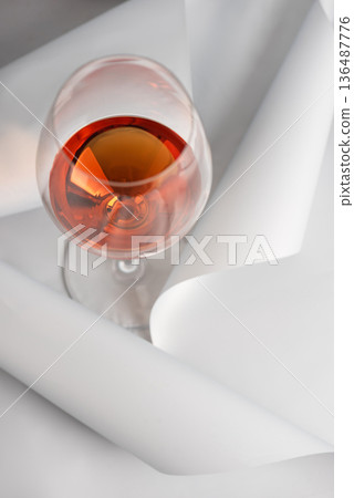 Rose Wine Glass on Minimal White Background. Elegant Modern Beverage Concept Rose Wine Glass on Minimal White Background. Elegant Modern Beverage Concept 136487776