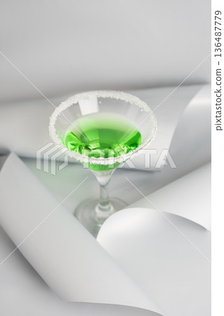 Green Cocktail with Sugar Rim. Festive Saint Patricks Day Minimal Still life Green Cocktail with Sugar Rim. Festive Saint Patricks Day Minimal Still life 136487779