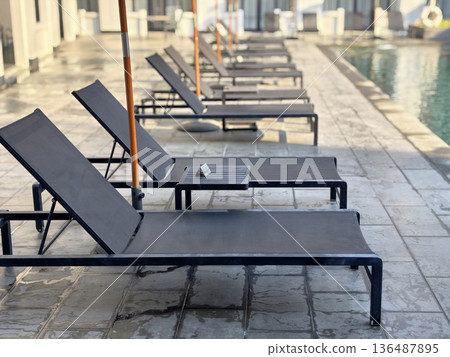 Swimming Pool and  Garden Relaxer Chair at the pool side. 136487895