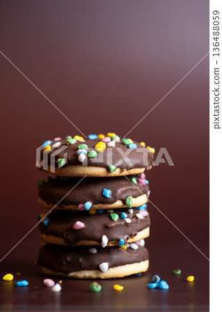 Colorful Chocolate-Dipped Cookies Stacked With Sprinkles Decor 136488059