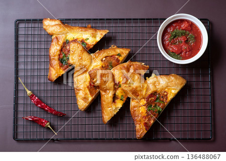 Savory Pastries Arranged Artistically With Dipping Salsa On A Table Savory Pastries Arranged Artistically With Dipping Salsa On A Table 136488067