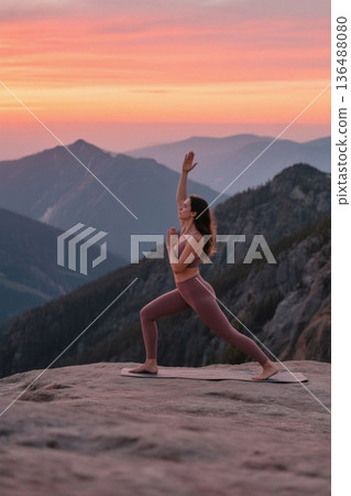 A woman doing yoga on a mountaintop A woman doing yoga on a mountaintop 136488080