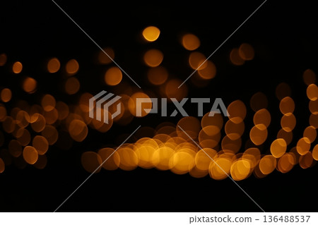 Golden Bokeh Lights on Black Background Golden Bokeh Lights on Black Background 136488537