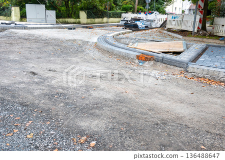 Repair reconstruction work on the asphalt road in big city. Street road renovation. 136488647