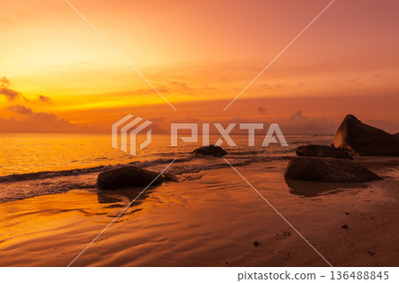 A picturesque beach scene in warm orange red hues 136488845