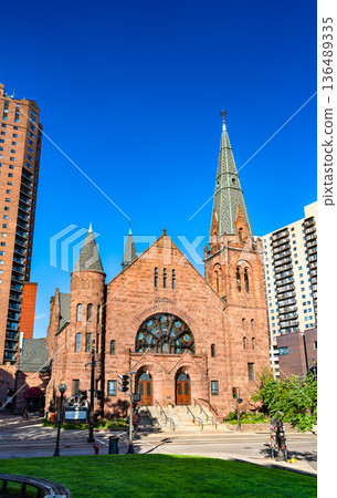 Central Presbyterian Church in St Paul Minnesota features historic Richardsonian Romanesque architecture with red sandstone and a tall green spire Central Presbyterian Church in St Paul Minnesota features historic Richardsonian Romanesque architecture with red sandstone and a tall green spire 136489335