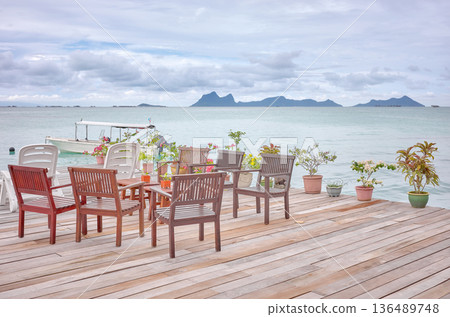 Wooden platform with seats by the sea, holiday relaxation concept, Borneo, Malaysia. Wooden platform with seats by the sea, holiday relaxation concept, Borneo, Malaysia. 136489748