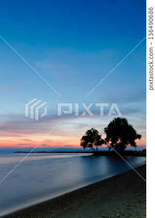 Twilight over Lake Biwa and silhouettes of trees_Vertical 136490686