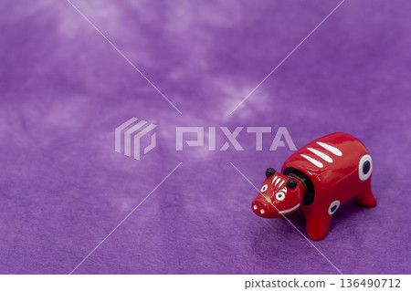 Akabeko placed on a purple Japanese paper background Akabeko placed on a purple Japanese paper background 136490712