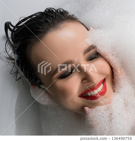 Happy brunette having bath high angle view 136490758