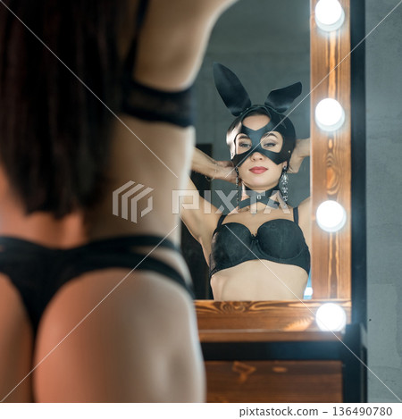 Woman in lingerie and bunny ears cropped rearview 136490780