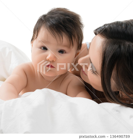 Baby and mother share a tender moment on a soft white blanket Baby and mother share a tender moment on a soft white blanket 136490789