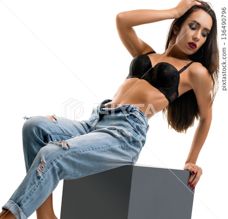 Model poses confidently in fashionable attire against a neutral backdrop Model poses confidently in fashionable attire against a neutral backdrop 136490796