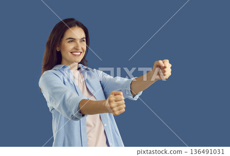 The girl imagines that she turns the steering wheel of her car. 136491031