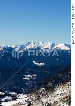 Stunning snow capped mountains under clear blue sky Stunning snow capped mountains under clear blue sky 136491350