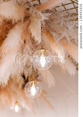 Pampas grass decor and pendant lights in modern dining interior Pampas grass decor and pendant lights in modern dining interior 136491858