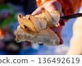 A hand holds grilled lard on bread, simple and tasty snack. 136492619