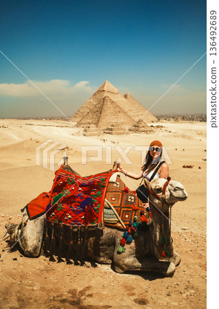 Woman With A Camel In Front Of The Pyramids Woman With A Camel In Front Of The Pyramids 136492689